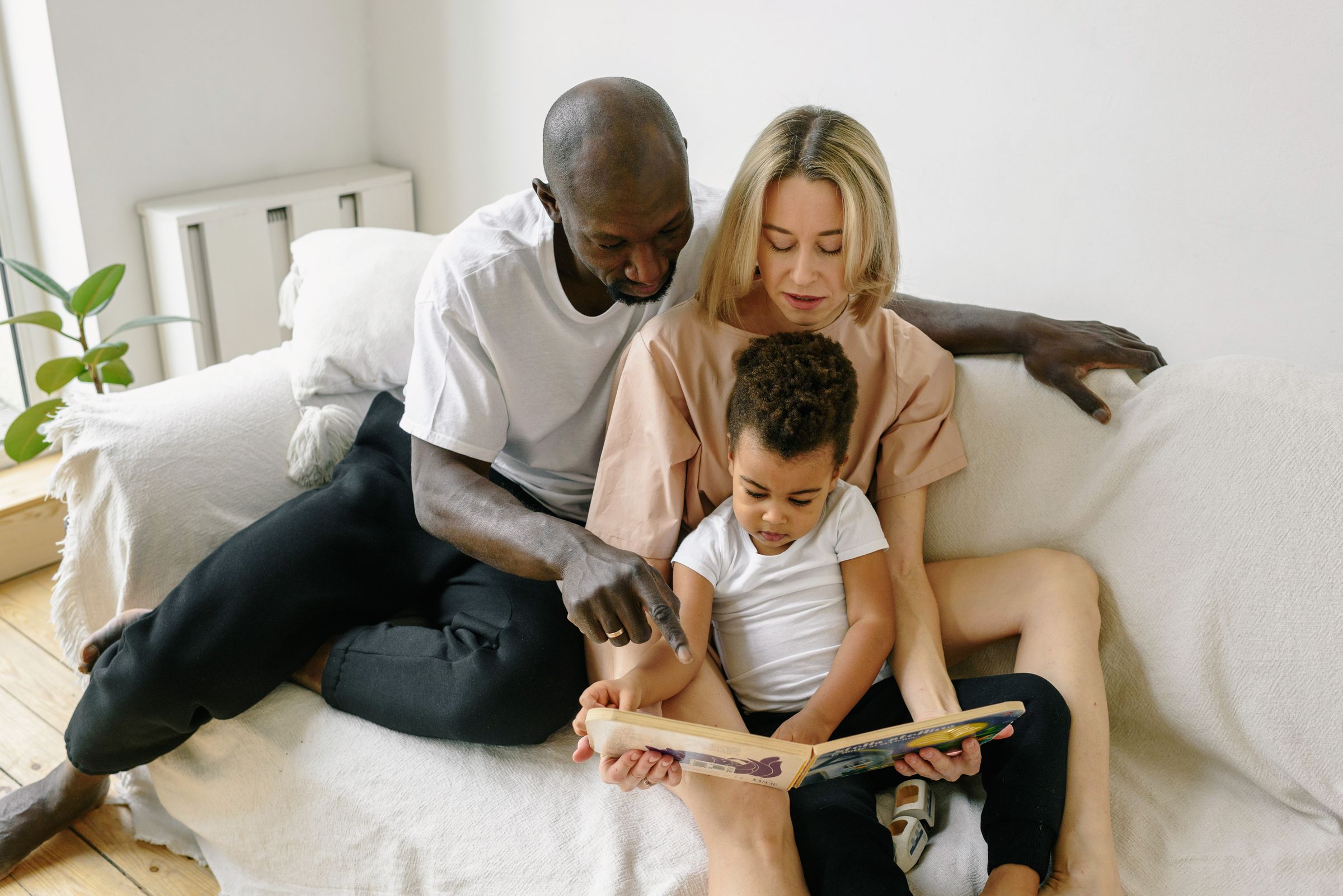 A host family reading a book together at home