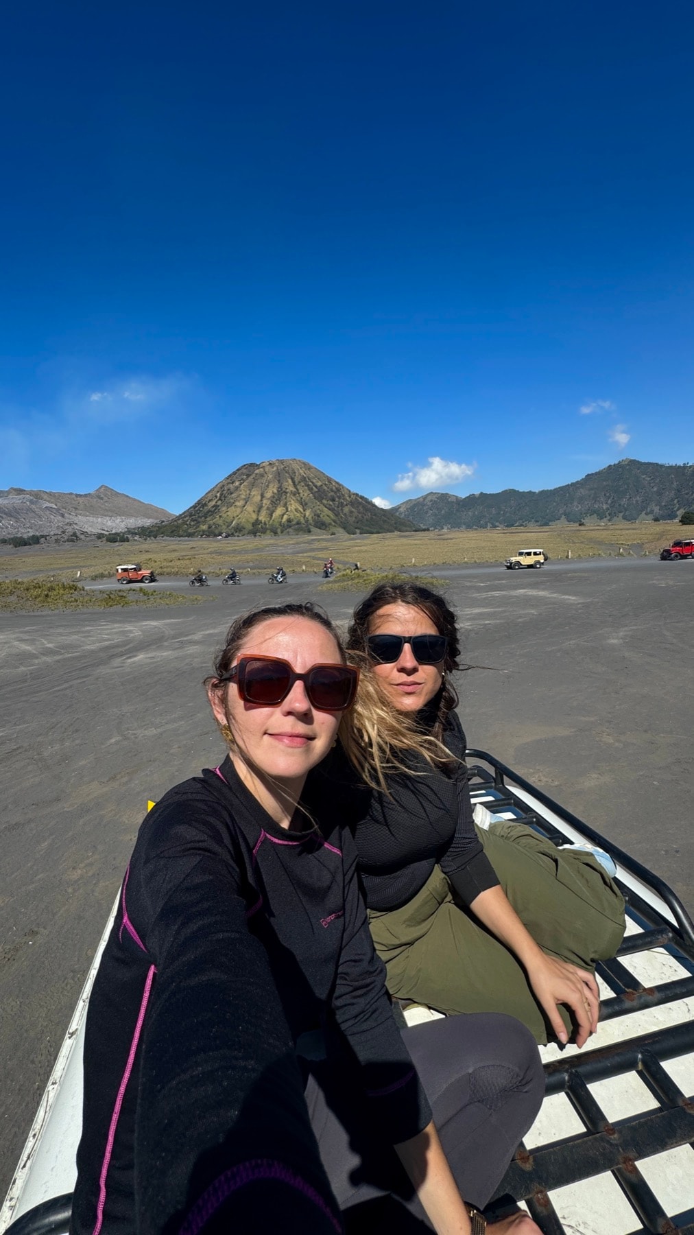 Two au pairs travelling together at a scenic volcano viewpoint